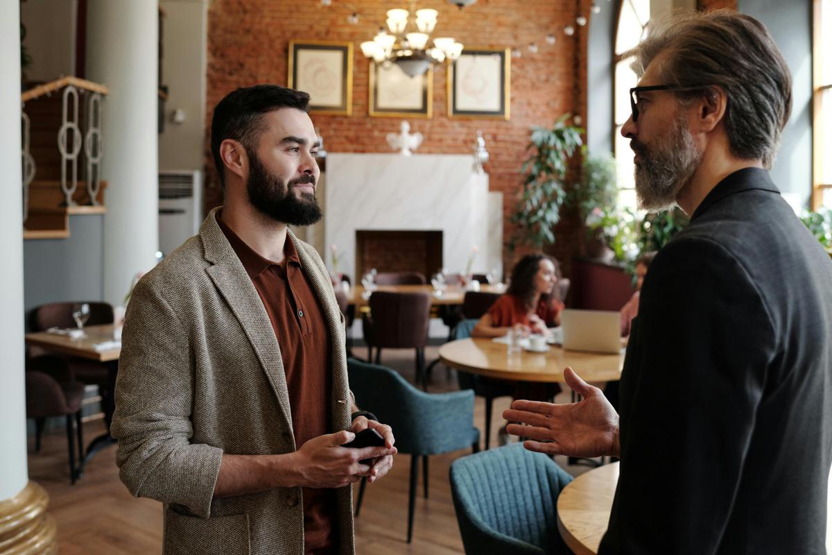People talking whilst standing in a cafe